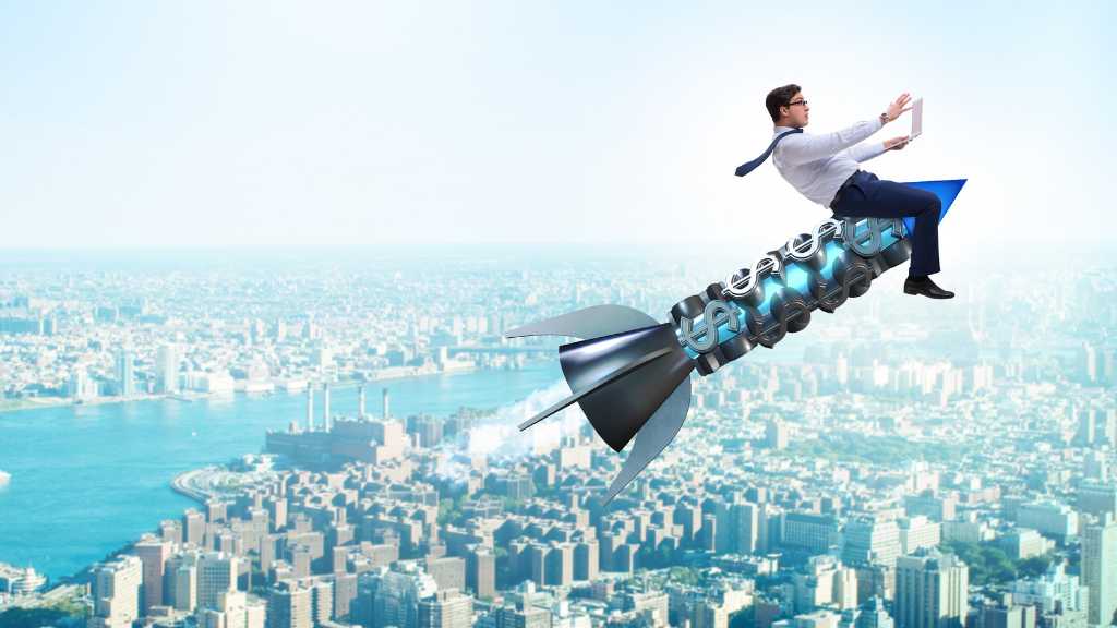 Eine Rakete, auf der ein Business-Mann sitzt, steigt in dem